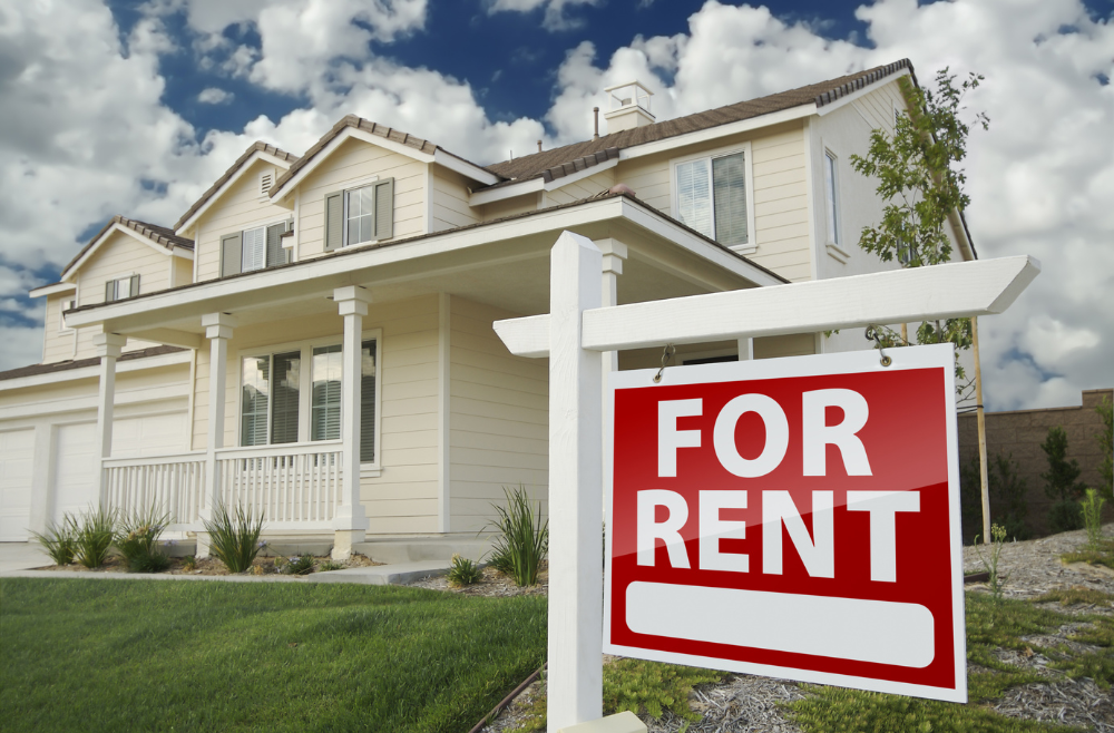 For Rent sign in front of house on the home rental market