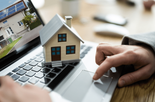 Las Vegas property management - miniature house sitting on top of a laptop keyboard