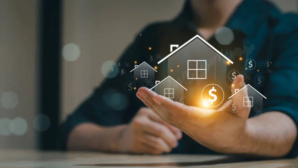 Hand holding glowing house outlines with a dollar sign