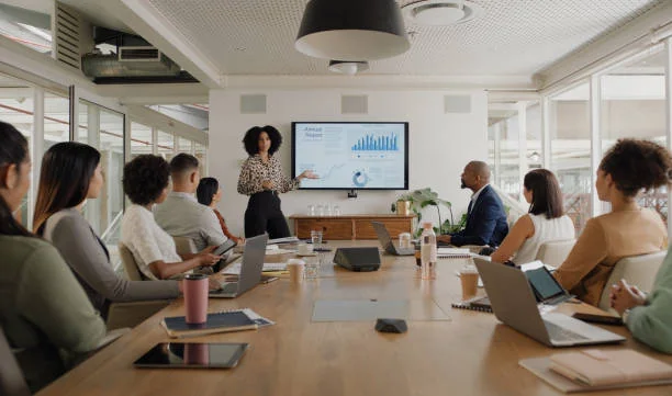 Team meeting with a chart presentation around a conference table
