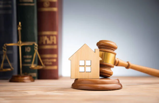 Wooden house with a gavel, scales of justice and law books