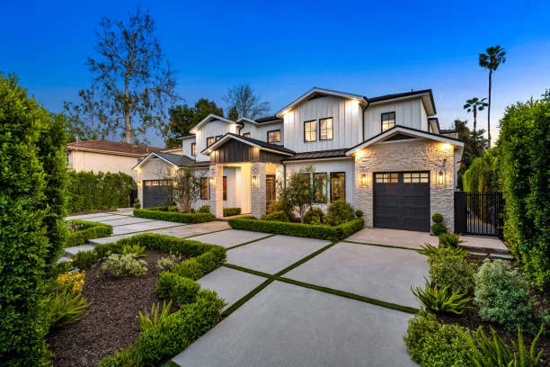 Modern white two-story house at dusk