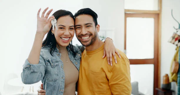 Happy couple holding up the keys to their new home
